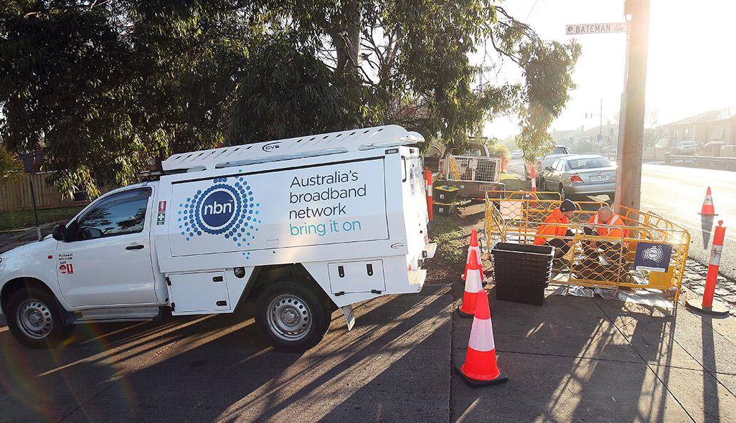 Photo of a nbn truck and nbn technicians working at a pit.